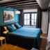 Hotel Brasserie Den Engel room in Baarle-Nassau with teal walls, double bed, and window view