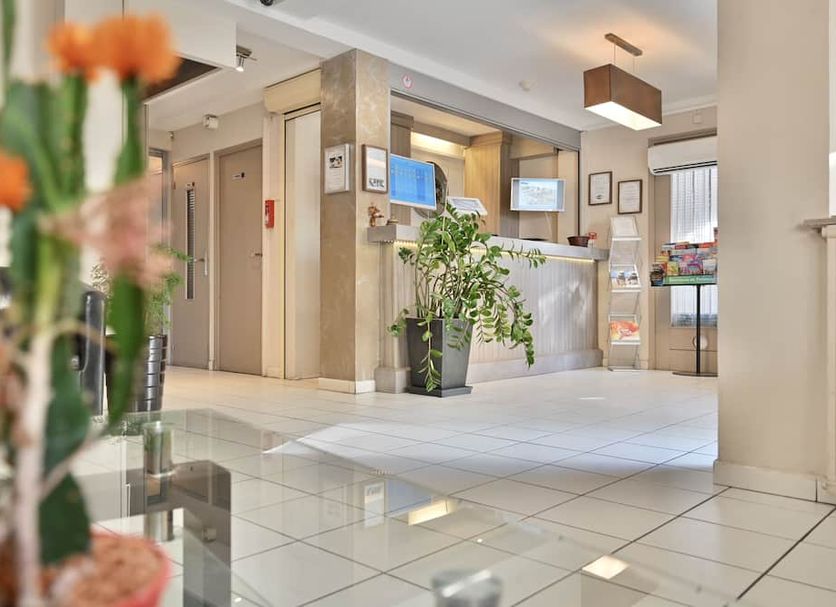 Hôtel La Rotonde in La Ciotat lobby with reception desk, elevator and tiled floor