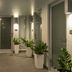 Marketplace Suites in St. John corridor with potted plants, glass doors, and tiled flooring