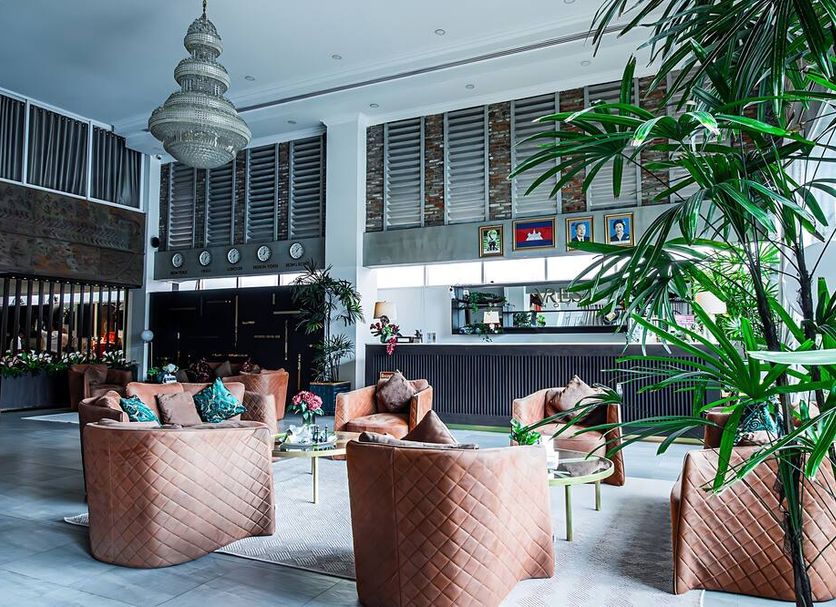 Vrest Hotel in Phnom Penh lobby with woven lounge chairs, large pendant light and bar area