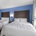 SureStay Plus by Best Western Niagara Falls East room with two double beds and blue accent wall