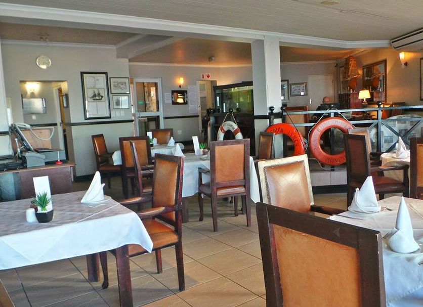Chapman Hotel and Conference Centre, Port Elizabeth dining room with set tables and chairs