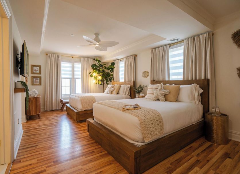 Coastal Chateau Ocean City guest room with two beds and bright windows