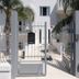 Residence O'Sole Mio Pompei in Pompei: white hotel entrance with metal gate and palm trees