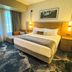 Rain Rock Casino Resort Hotel in Yreka guest room with king bed, sofa, and window view