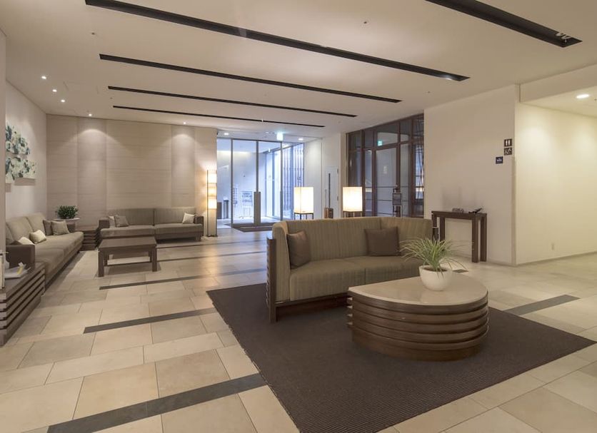 Richmond Hotel Kumamoto Shinshigai lobby with seating, coffee table, and large glass entrance