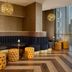 DoubleTree by Hilton Hull lounge seating with curved banquette, tufted stools and pendant lights