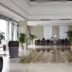 Xiang Ming Holiday Hotel in Huangshan lobby with polished tile floors, potted palms, and seating area