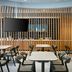SpringHill Suites by Marriott Orange Beach at The Wharf dining area with tables, chairs, and TV