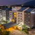 Courtyard by Marriott San Salvador hotel exterior at night with lit entrance and mountain backdrop
