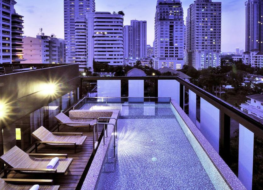 Hiptique Sukhumvit 13 Bangkok rooftop pool with city skyline at dusk