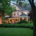 Beaufort House Inn in Asheville, Victorian inn with lit porch, manicured lawn and trees