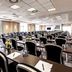 Conference room at pentahotel Eisenach in Eisenach with rows of tables and black chairs