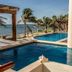 Aquastar Hotel & Apartments in Majahual with oceanfront pool, palm trees, and sea view