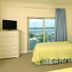 Crystal Towers Gulf Shores guest room with twin bed, balcony door and bay view