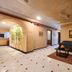 Park Palace Hotel Kolkata lobby with sofas, coffee table, tiled floor and arched hallway