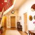 Laston House, Ilfracombe: staircase and hallway with floral wallpaper, clock, and red upper landing
