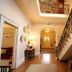 Laston House Ilfracombe hallway with staircase, wooden floor, and ornate railing