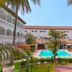 Sarges Hotel in Serrekunda with a central outdoor pool and palm trees between white buildings