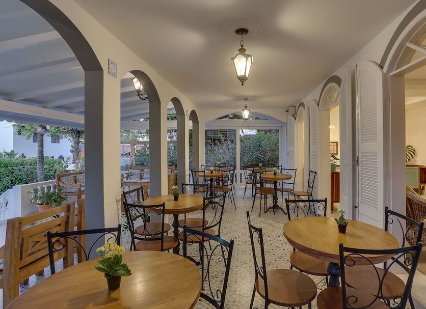 Solar Beach Hotel in Florianopolis terrace dining area with arched corridor and wooden tables