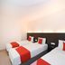 Kenyalang Suite Miri guest room with three single beds and red accents