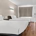 Studio 6 San Luis Obispo Ca South guest room with two beds, desk, chair and wood flooring
