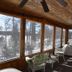 Lakeside Bed & Breakfast in Florence sunroom with wicker seating and snowy wooded views