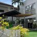 Seabird International Resort in Boracay with a courtyard, green lawn, hammock, and palm trees