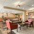 Red Roof Inn Baltimore South - Glen Burnie lobby seating area with tables, chairs, and vending machine