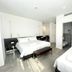 Le Muraine in Bergamo guest room with two beds and a bathroom doorway