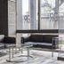 GR Hotel Ginzadori in Kumamoto lobby seating area with black sofas and a glass coffee table by large windows