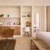 Atlantic Byron Bay guest suite with kitchenette, lounge chair, and bed in Byron Bay