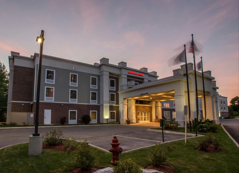 Hampton Inn & Suites Berkshires-Lenox exterior at dusk with covered entrance in Lenox