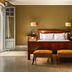 Fonda Hotel 1771 in Granollers: guest room with wood bed, benches and olive walls