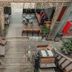 House Of Passion Amphawa courtyard with wooden deck seating and plants in Amphawa