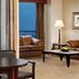 Sheraton Atlanta Airport Hotel suite with city view, sofa, lamp and dining table in Atlanta