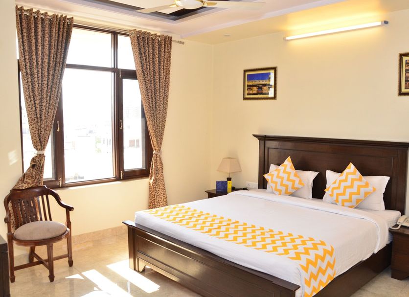Raj Regency Jaipur guest room with double bed, window, and seating area