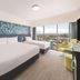 Vibe Hotel Gold Coast, Surfers Paradise: twin beds, balcony with city view, and modern guest room