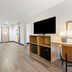 Spark by Hilton Harrisonburg University Area room with sofa, TV and wood flooring in Harrisonburg