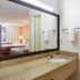 Motel 6 Clarksville Tn bathroom vanity with mirror, sink, and tub shower area in Clarksville