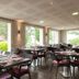 Charme Hotel & Spa in Arbouans restaurant with large windows and outdoor garden views