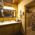 Black Bear Lodge Motel in Slade bathroom vanity with mirror, sink, and shower curtain