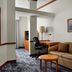 Fairfield Inn & Suites by Marriott Indianapolis East guest room with sofa, desk and chair