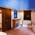 Rvhotels Palau Lo Mirador bathroom with tiled floor, corner tub, fireplace and arched mirror in Torroella de Montgrí