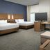 Residence Inn by Marriott Lubbock-University Area room with two beds, desk, sofa and TV in Lubbock