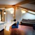 Zenit El Coloquio in Valladolid: loft-style hotel room with exposed beams, king bed, sofa and desk