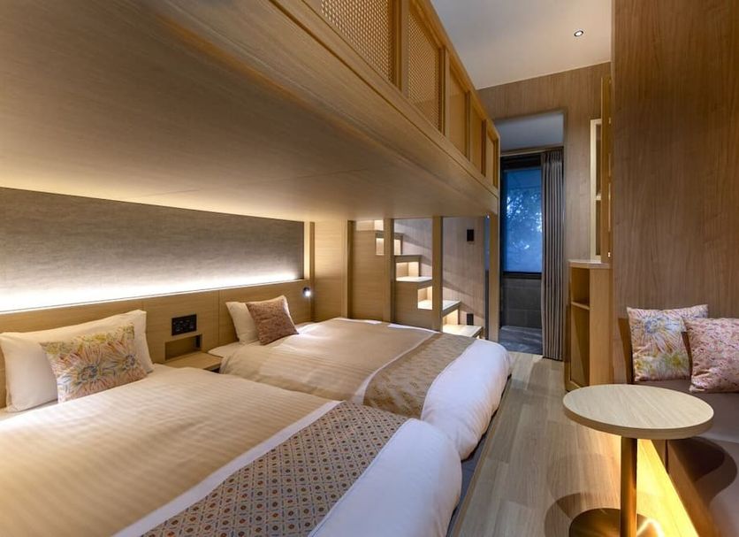 Fujisan Station Hotel in Fujikawaguchiko, twin beds with wood-paneled room and seating area