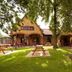 Premier Inn Glasgow East exterior with picnic benches on a grassy lawn and trees in Glasgow