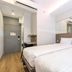 Easy Planet Bangkok Surawong in Bangkok guest room with two twin beds and wall mirror