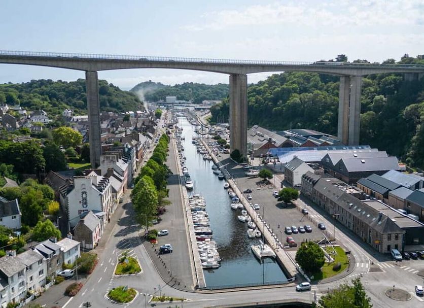 Quick Palace Saint Brieuc in Saint-Brieuc with canal, boats, bridge, and hillside town view